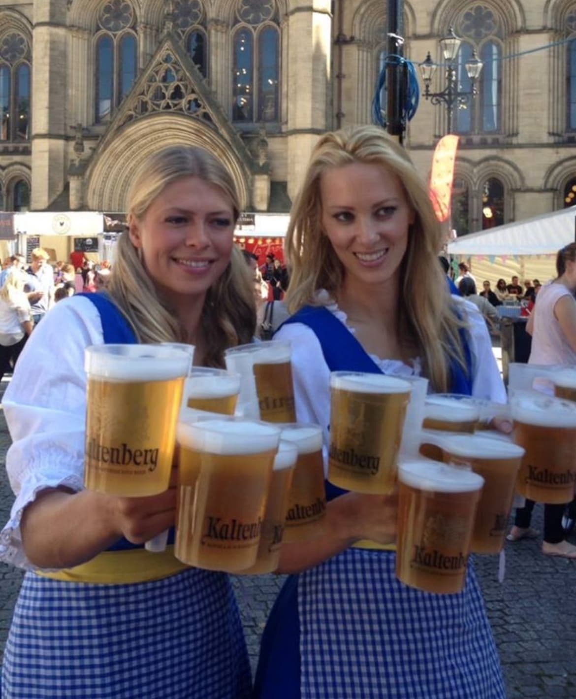 Bartender easily stacking multiple pints for a customer at a busy bar